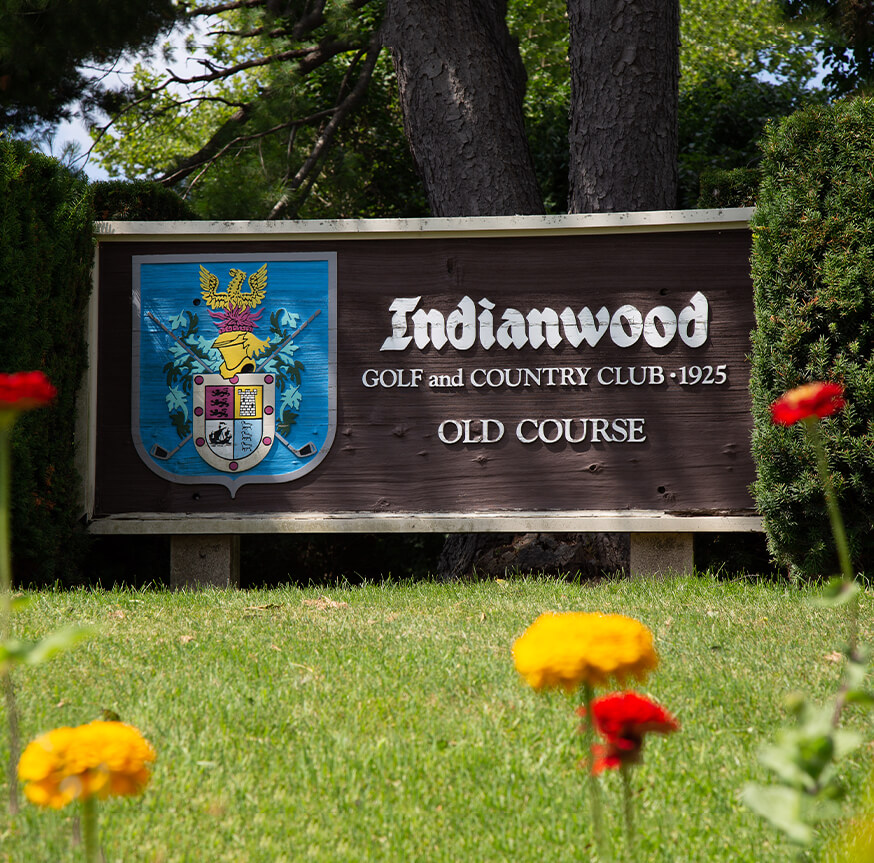 Indianwood Country Club sign with flowers